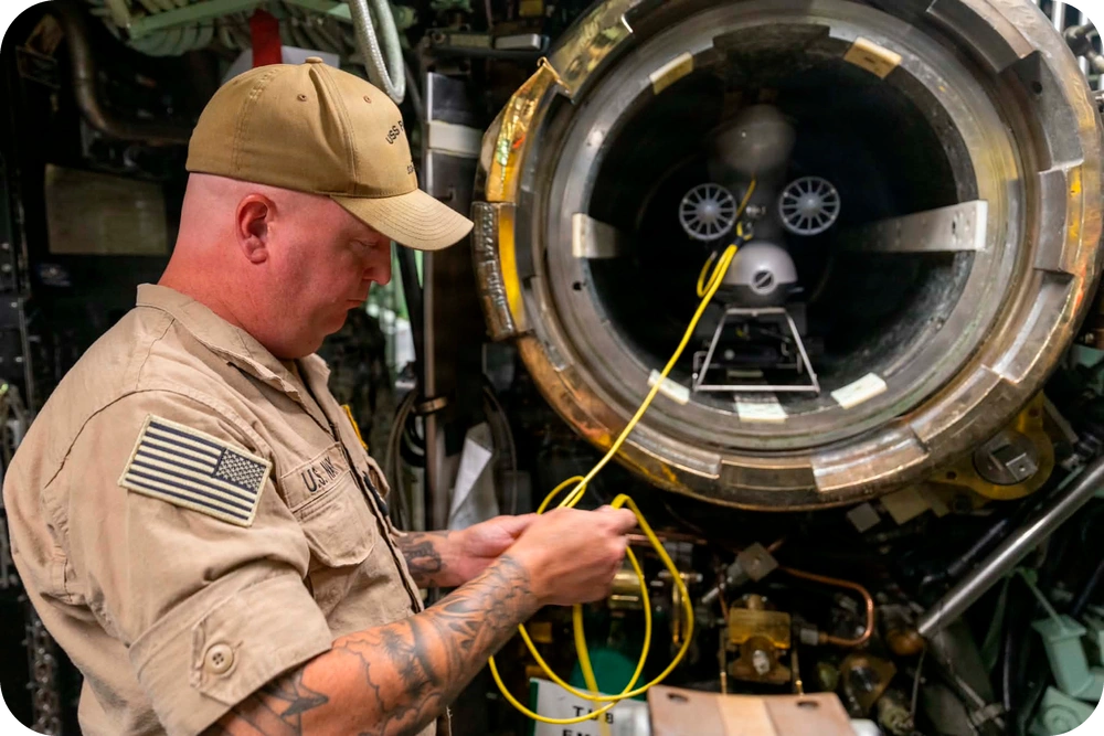 Chief Fire Control Technician Will McCrary checks connections on a Blueye X3 remotely operated vehicle (ROV) before a test launch from a torpedo tube aboard Los Angeles-class fast-attack submarine USS Pasaden. Photo via Petty Officer 2nd Class Mailani Jones-Thornto.